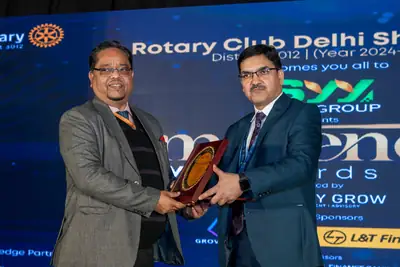 Eminence MSME Awards: Two guests holding an award plaque on stage