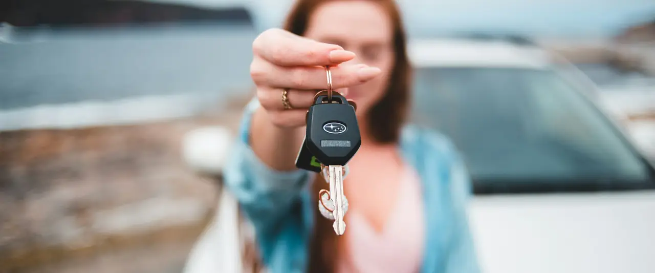 Person holding the keys to a new car