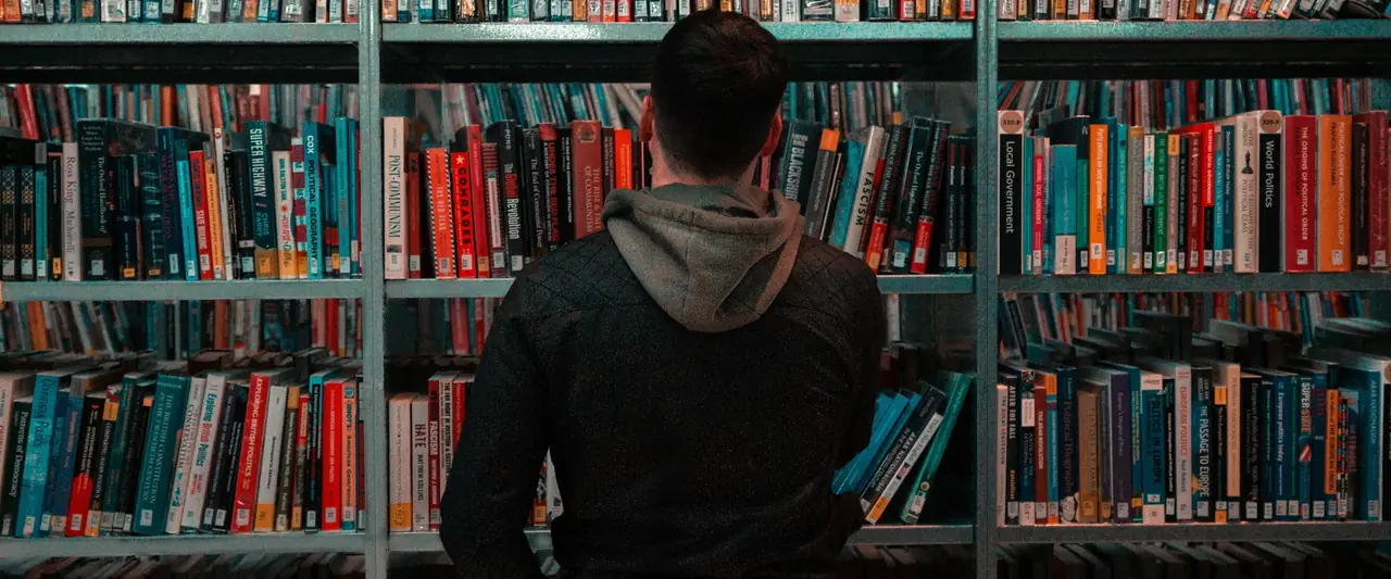 Student choosing books in a library