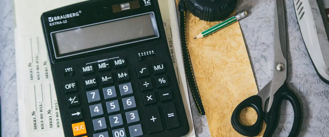 Calculator and paperwork on an office desk