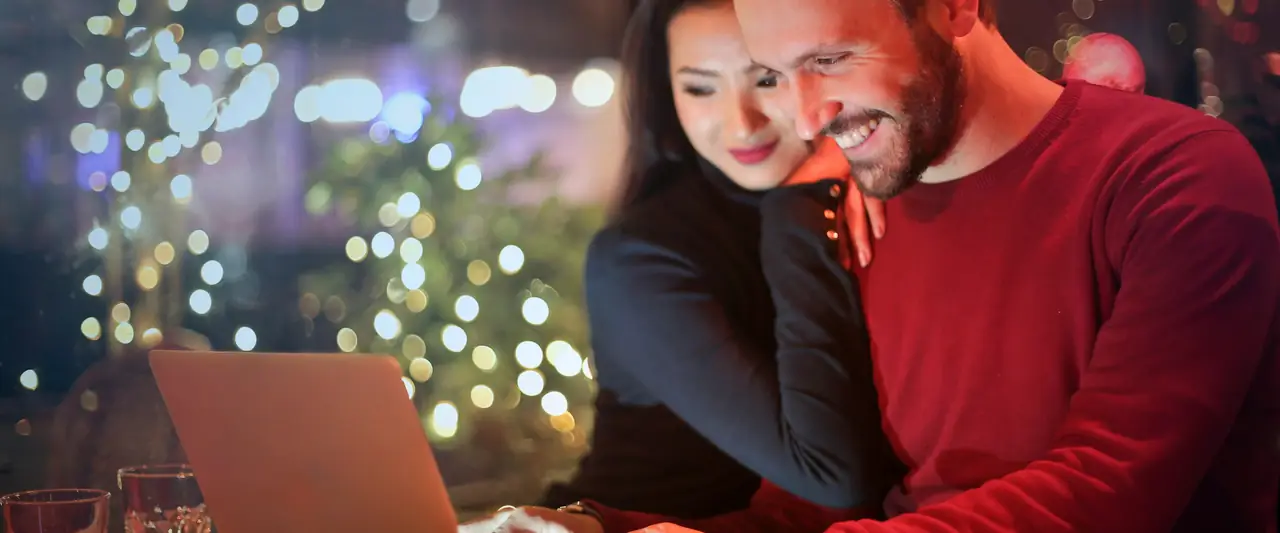 Couple planning their finances on a laptop