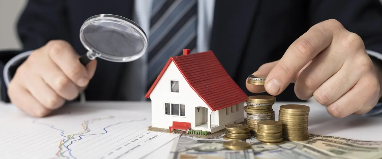 House model under a magnifying glass for property evaluation