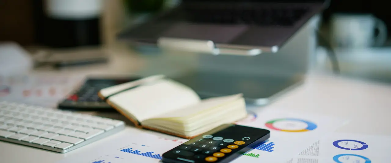 Financial charts and calculations on a desk